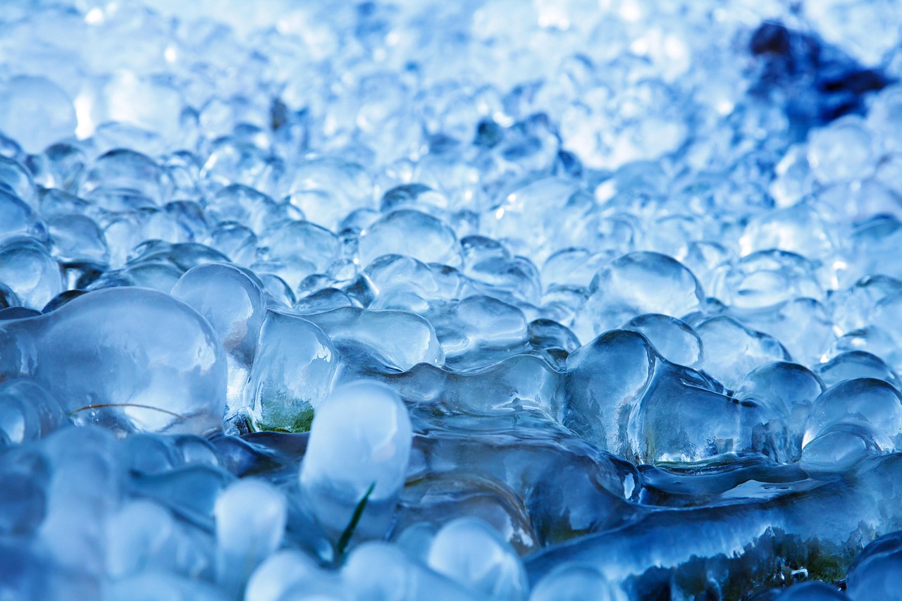Chunks of ice near a river, symbolizing the raw elements used in cold plunge therapy in the Peruvian Andes.